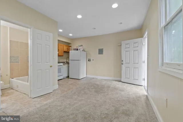 a view of a kitchen with a sink an oven and refrigerator