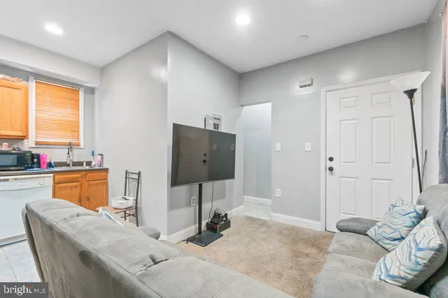 a bedroom with furniture and a flat screen tv
