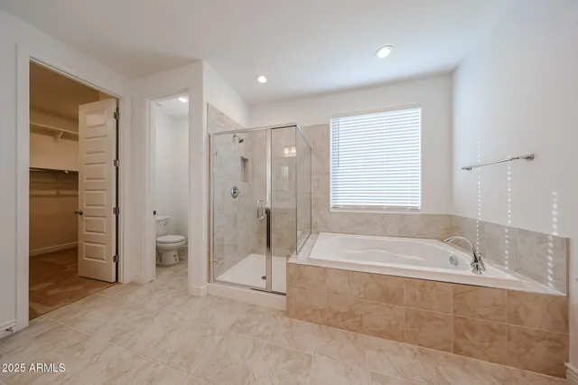 a spacious bathroom with a tub shower and sink