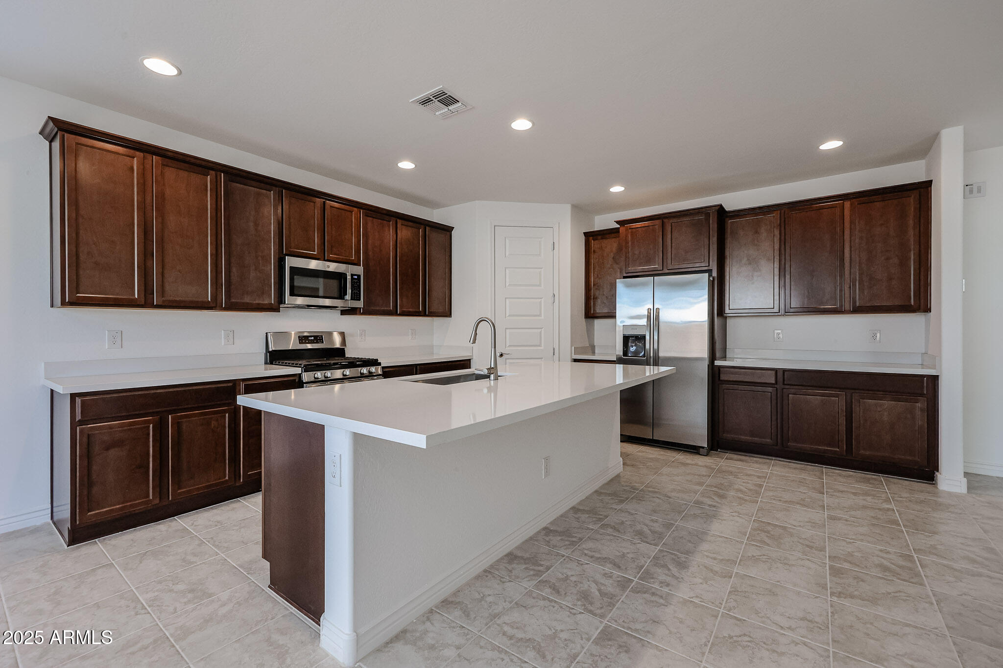 25128 North 171st Avenue Surprise, AZ 85387 - Photo 2 of 22 a kitchen with kitchen island granite countertop stainless steel appliances and sink