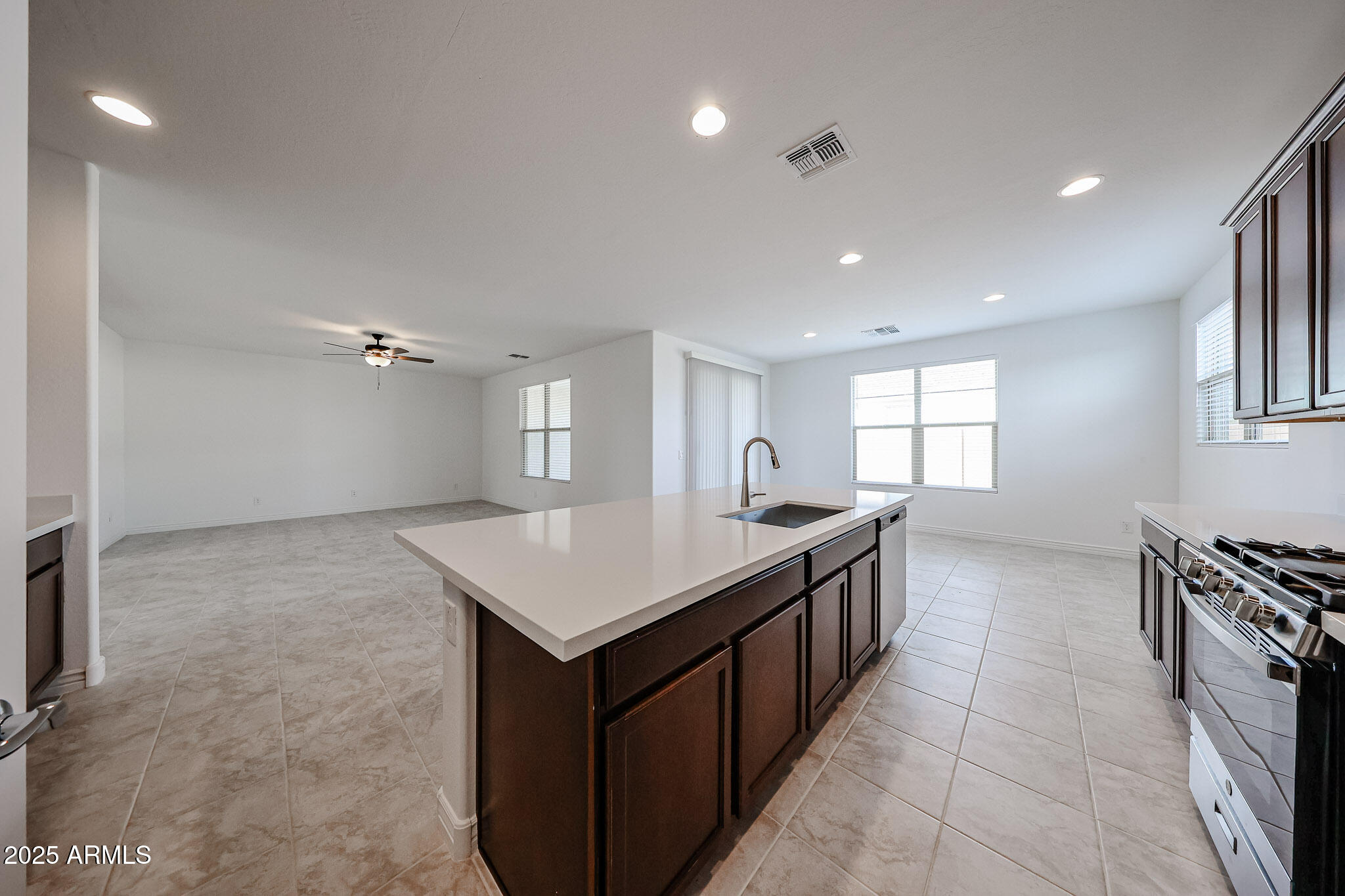 25128 North 171st Avenue Surprise, AZ 85387 - Photo 3 of 22 a kitchen with a stove a sink a microwave and a refrigerator