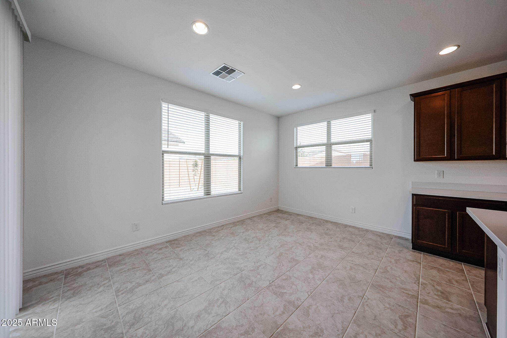25128 North 171st Avenue Surprise, AZ 85387 - Photo 5 of 22 a view of an empty room with a window and a kitchen