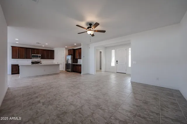 a view of a kitchen with a stove cabinets and a ceiling fan