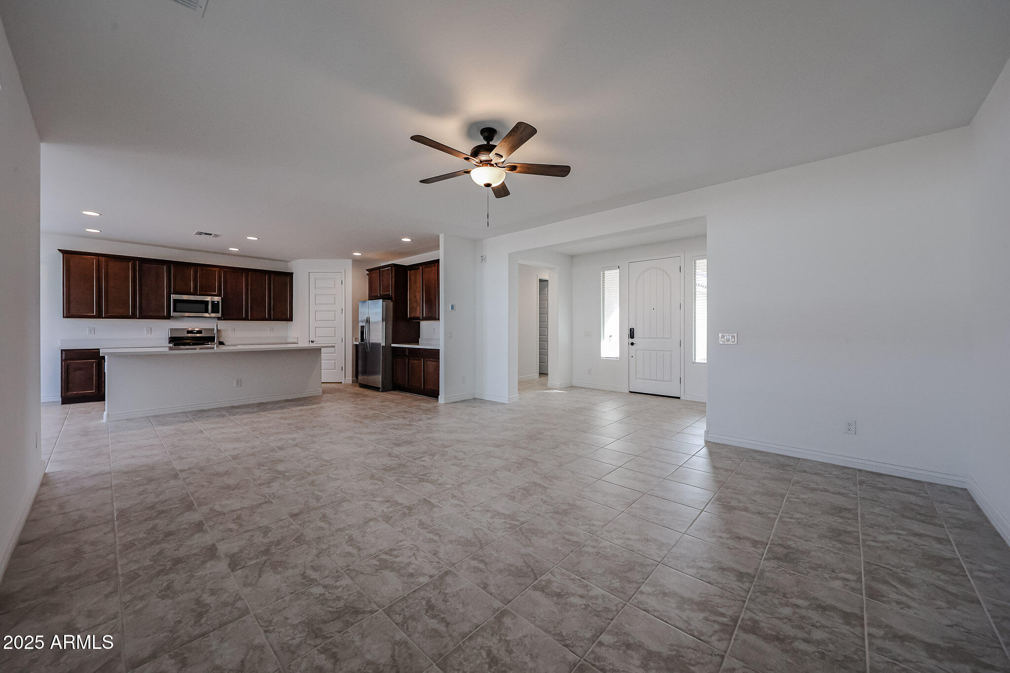 25128 North 171st Avenue Surprise, AZ 85387 - Photo 6 of 22 a view of a kitchen with a stove cabinets and a ceiling fan