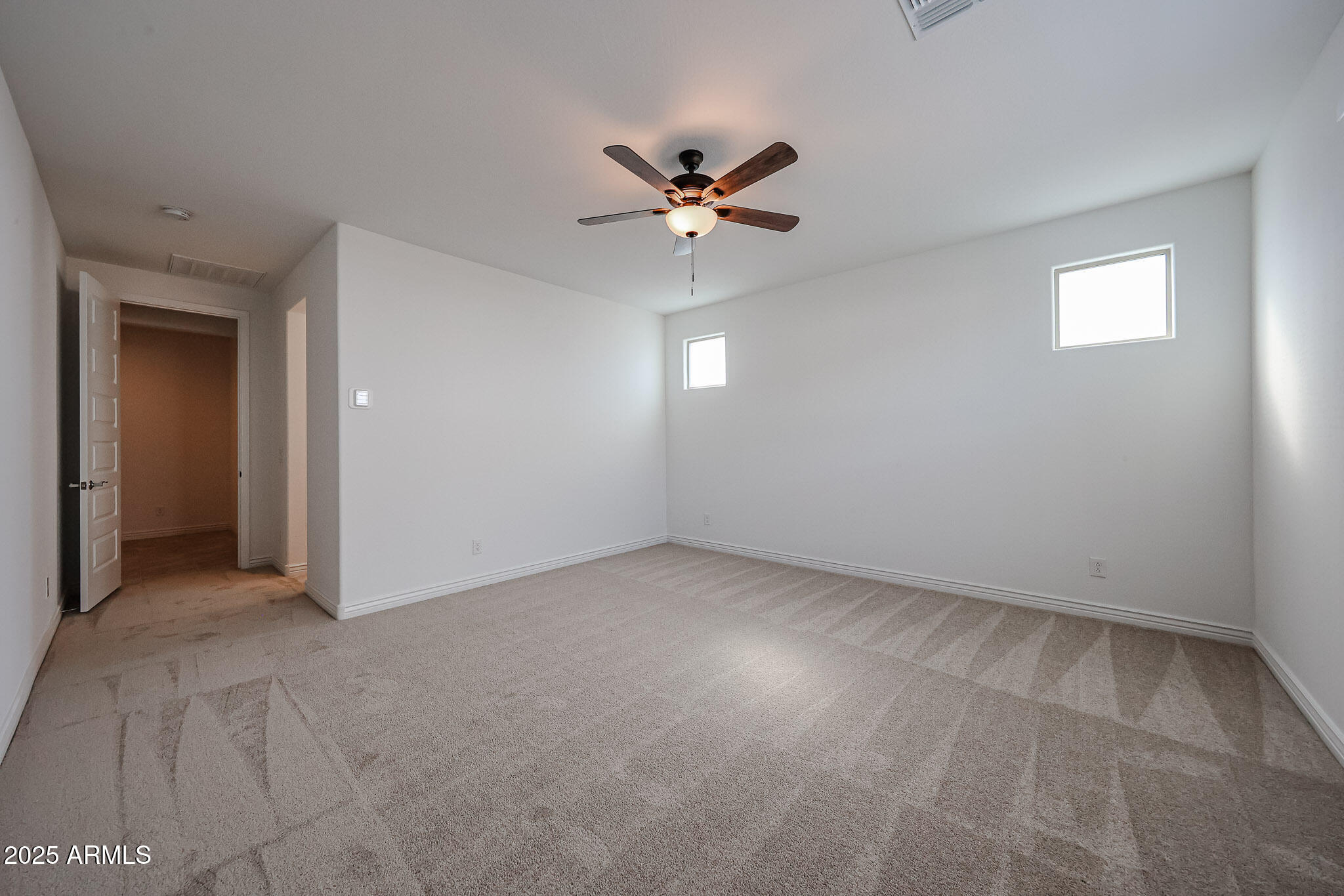 25128 North 171st Avenue Surprise, AZ 85387 - Photo 9 of 22 an empty room with closet and a ceiling fan