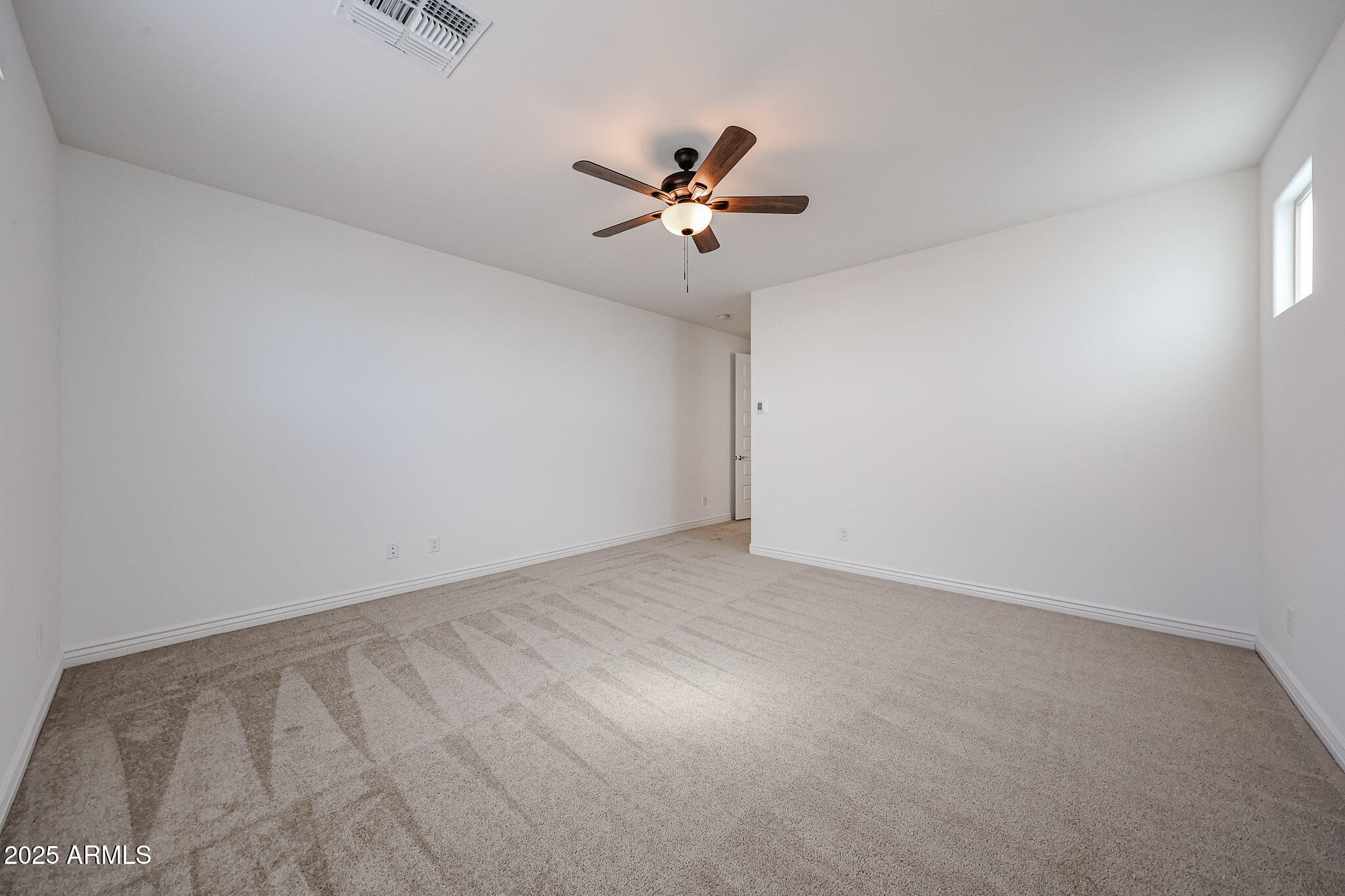25128 North 171st Avenue Surprise, AZ 85387 - Photo 10 of 22 an empty room with a window and a ceiling fan