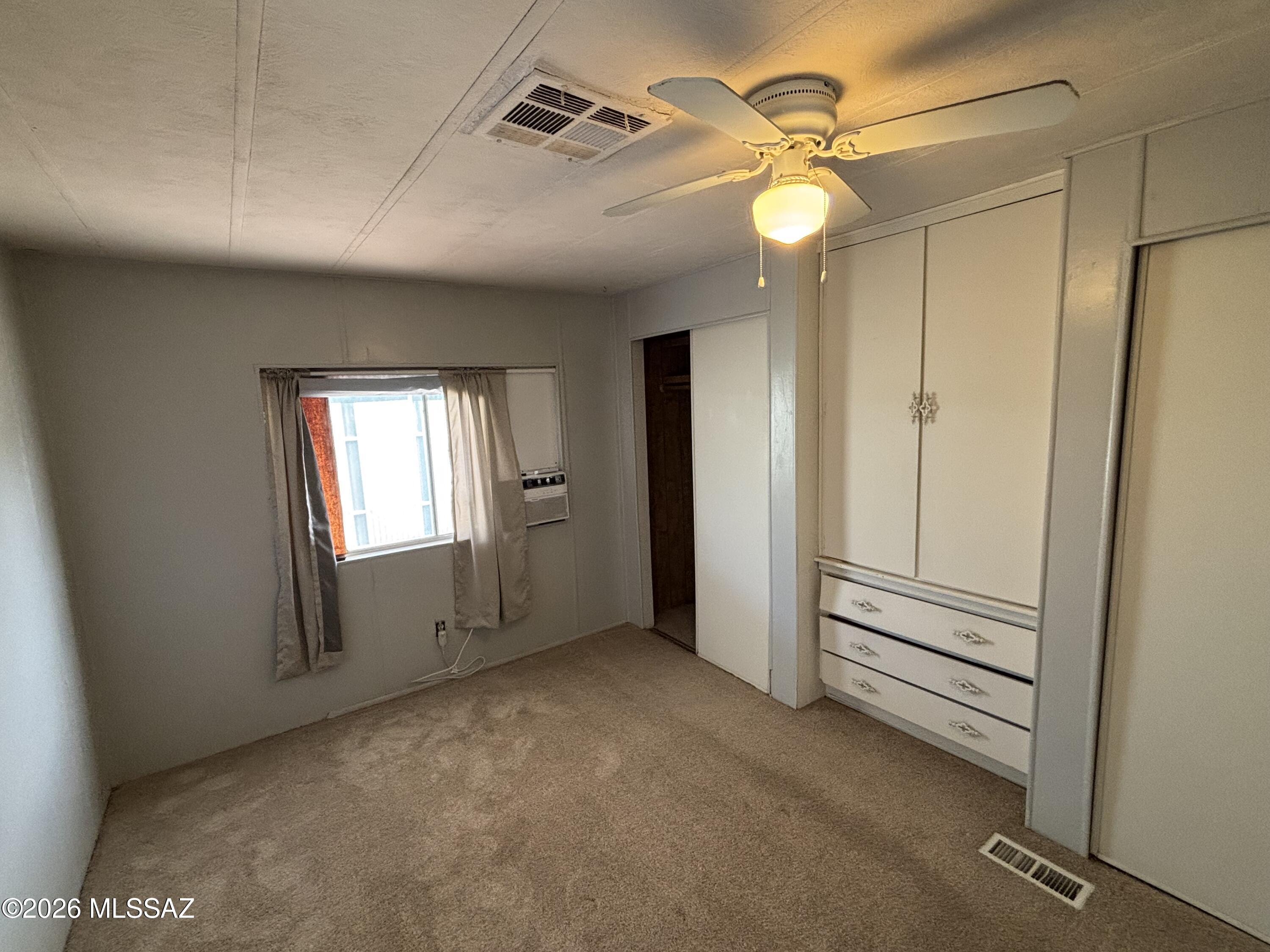 4550 North Flowing Wells Road, Unit 65 Tucson, AZ 85705 - Photo 16 of 50 a view of empty room with a ceiling fan