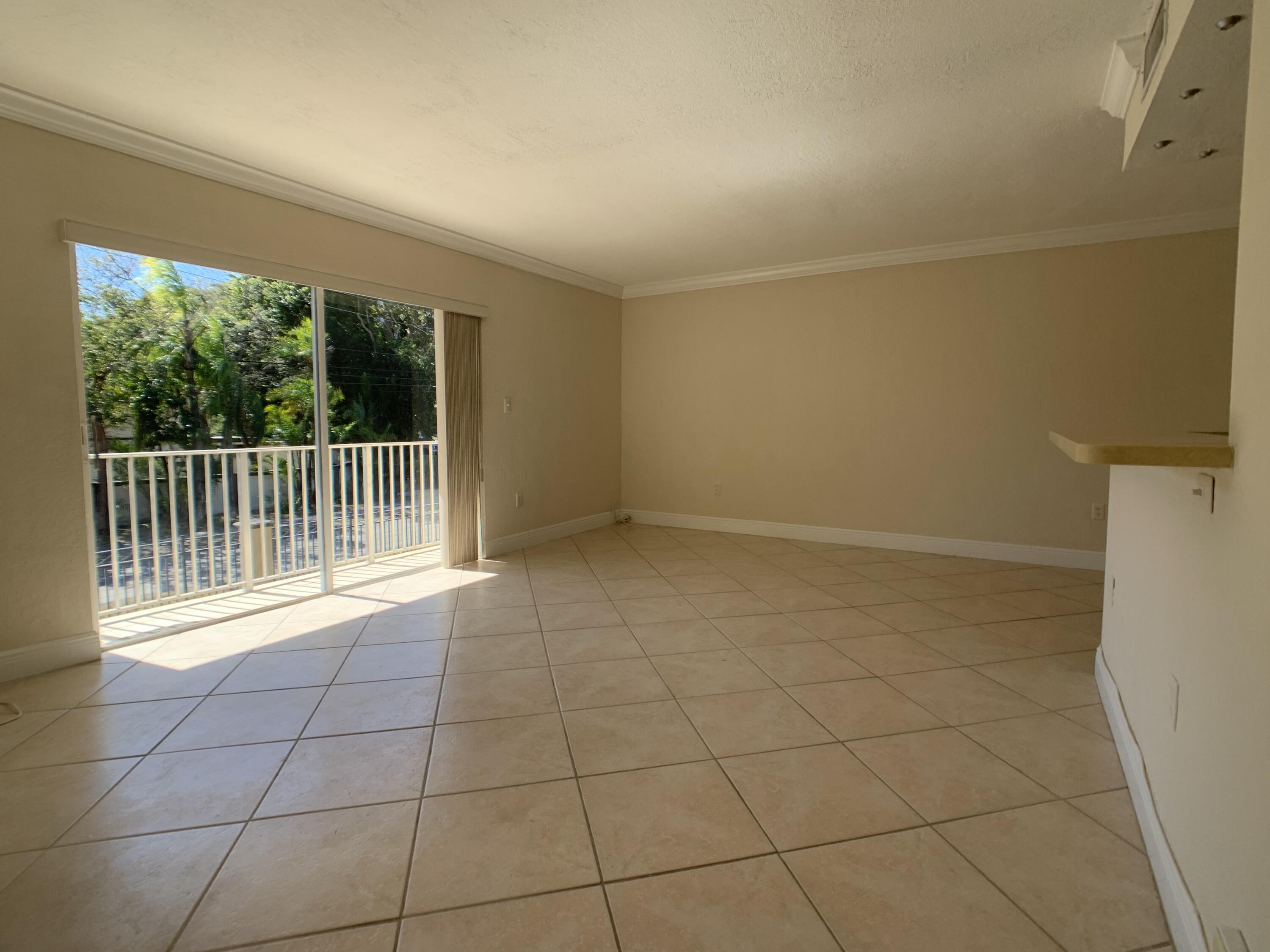 8601 Southwest 94th Street, Unit 201W Miami, FL 33156 - Photo 4 of 14 a view of an empty room with a window