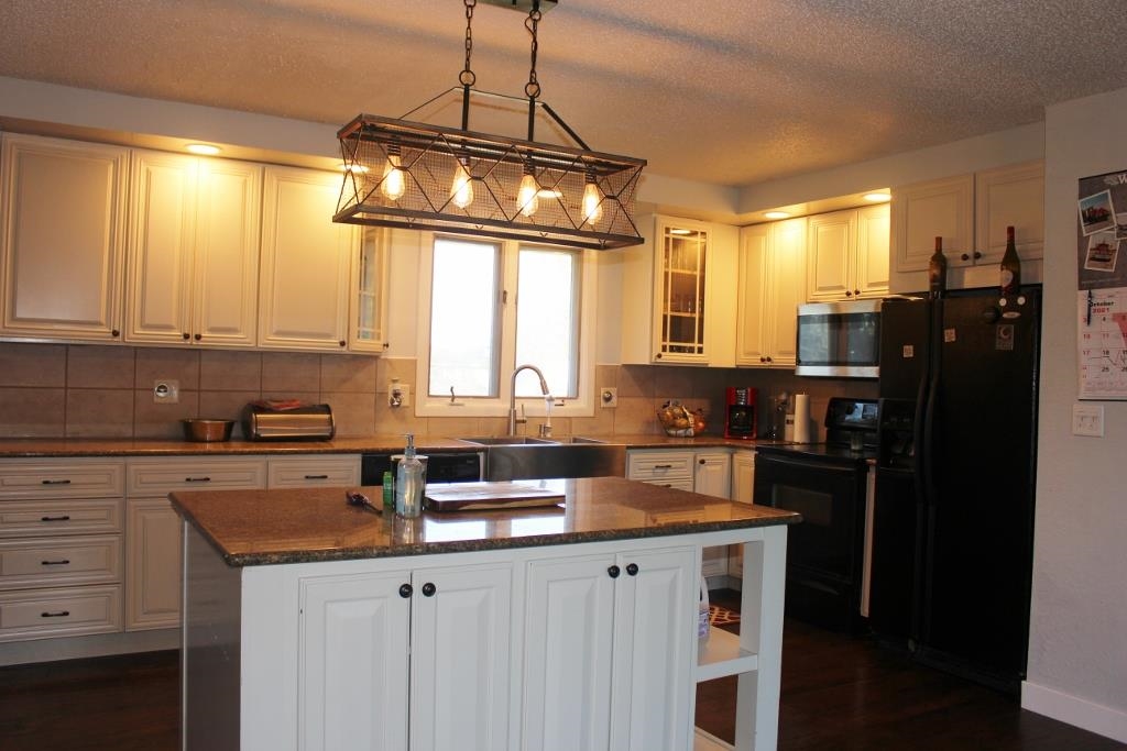2870 Karr Road Belvidere, IL 61008 - Photo 3 of 22 a kitchen with granite countertop cabinets a window and stainless steel appliances