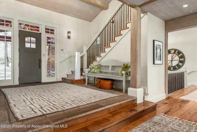 a living room with furniture a flat screen tv and large window