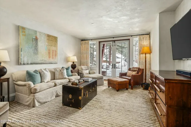 a view of a hallway with wooden floor and stairs