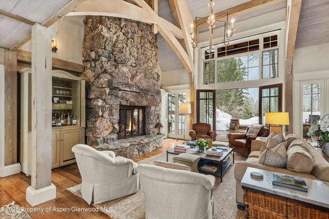 a living room with furniture windows and a fireplace