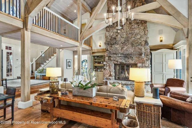 a kitchen with stainless steel appliances granite countertop a sink a stove and chairs