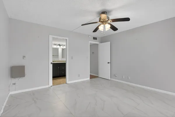 a bathroom with a granite countertop sink toilet a mirror and shower