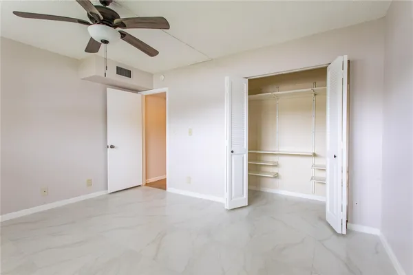 a bathroom with a granite countertop sink a toilet and a mirror
