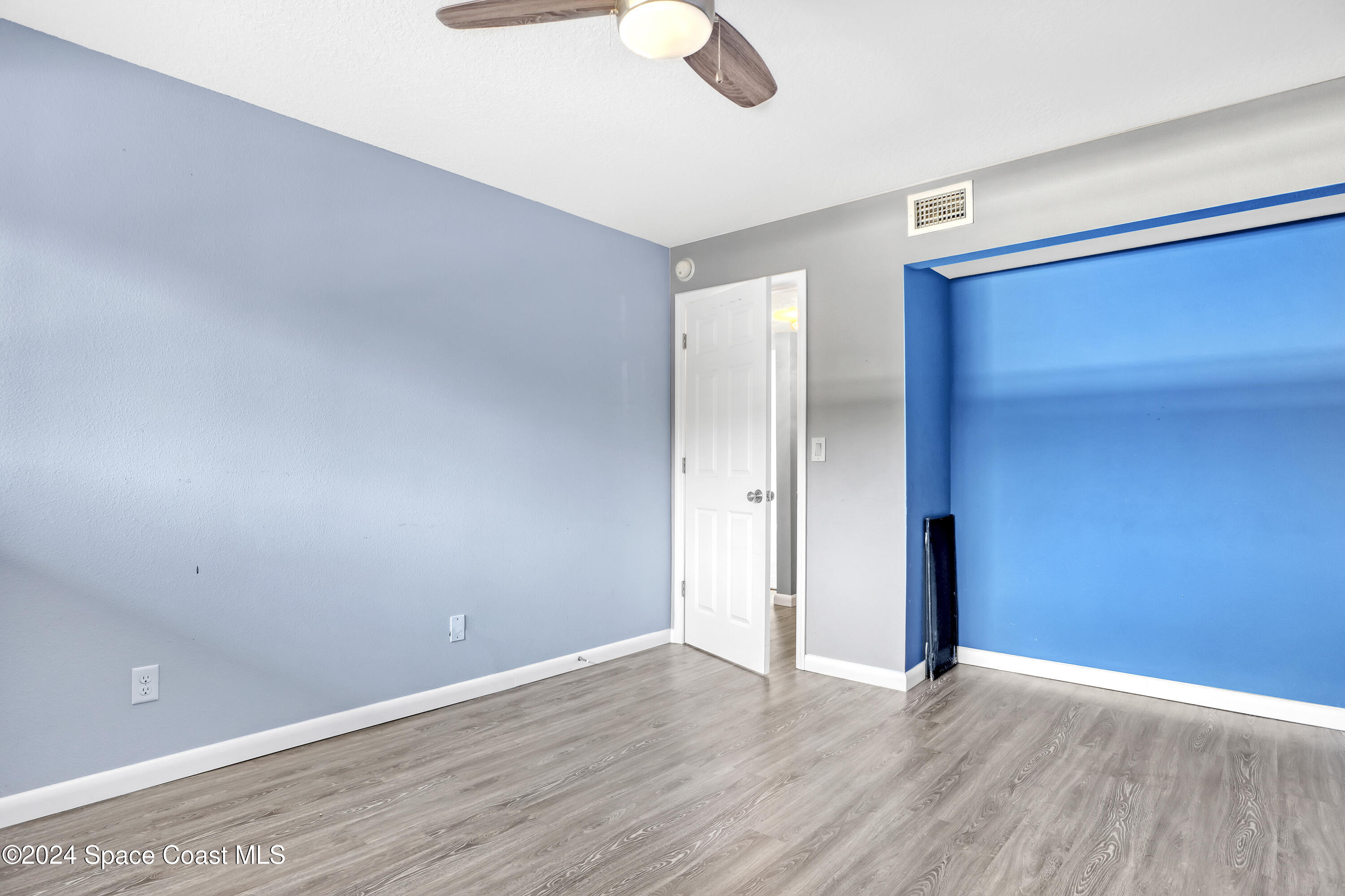 3901 Dixie Highway Northeast, Unit 209 Palm Bay, FL 32905 - Photo 19 of 49 a view of an empty room with wooden floor