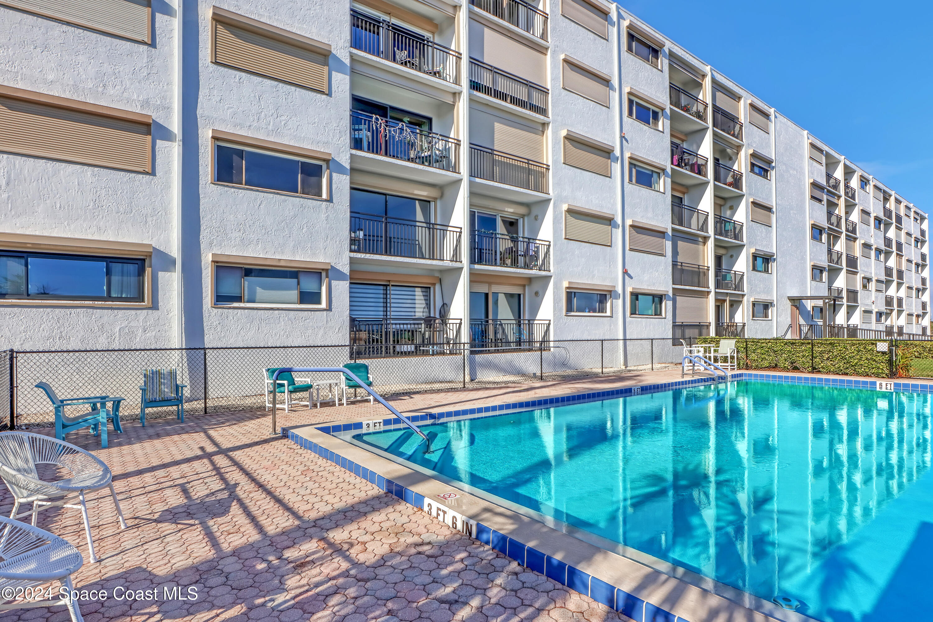 3901 Dixie Highway Northeast, Unit 209 Palm Bay, FL 32905 - Photo 42 of 49 a view of building with swimming pool and sitting area