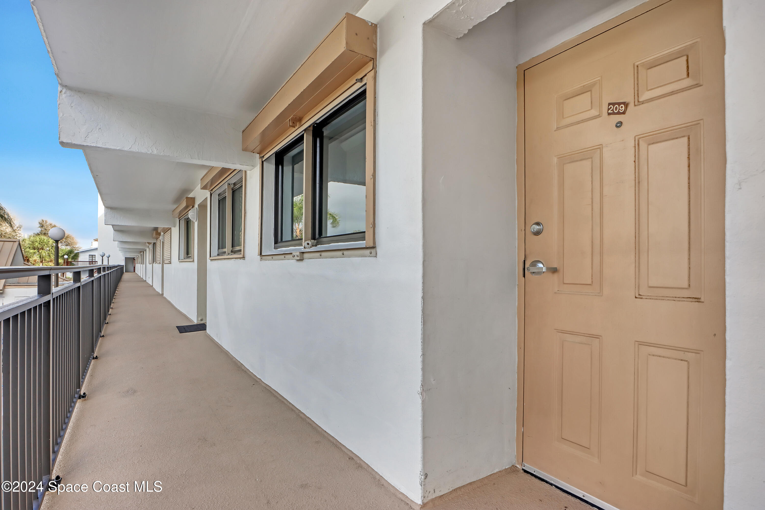 3901 Dixie Highway Northeast, Unit 209 Palm Bay, FL 32905 - Photo 48 of 49 a view of a hallway with windows
