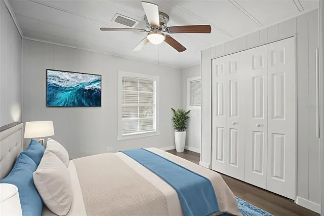 a living room with furniture a flat screen tv and a window