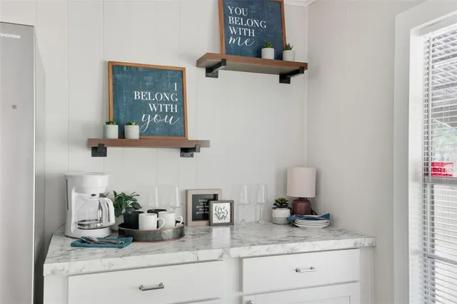 a kitchen with granite countertop a stove and a wooden floors