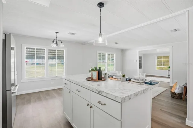 an empty room with windows and wooden floor