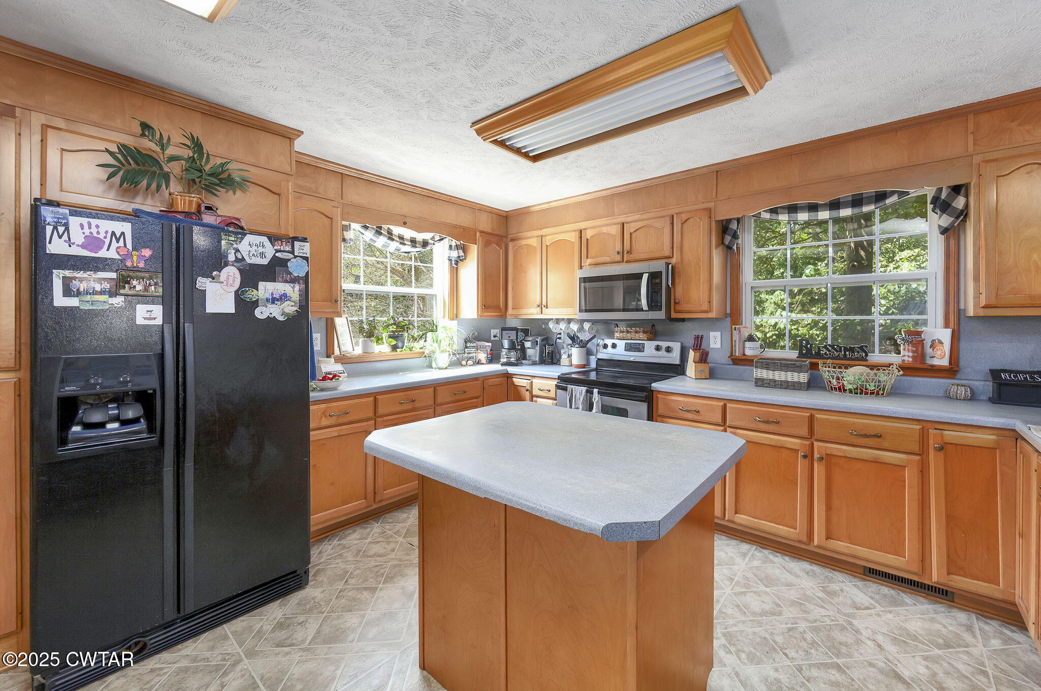 50 Braund Road Finger, TN 38334 - Photo 12 of 65 a kitchen with stainless steel appliances granite countertop a refrigerator a sink a stove and a refrigerator