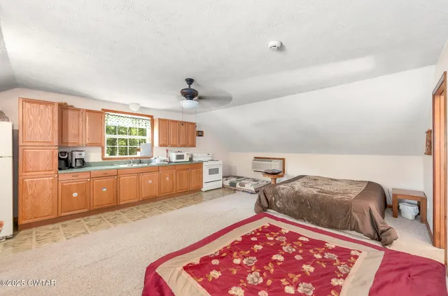 a view of a house with a big yard and large trees