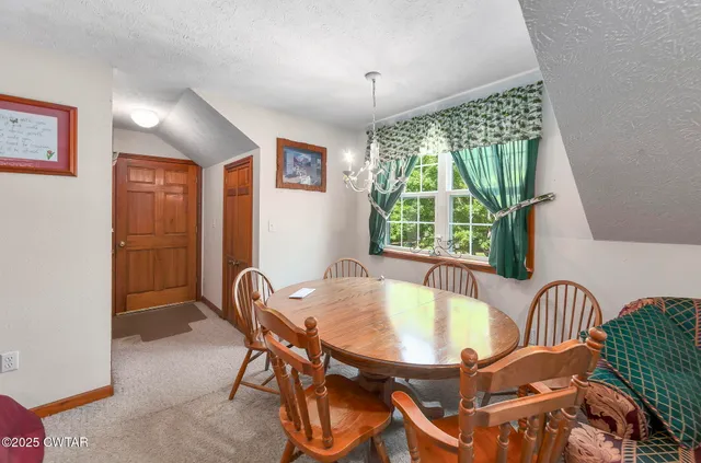 an aerial view of a house with a yard and lake view