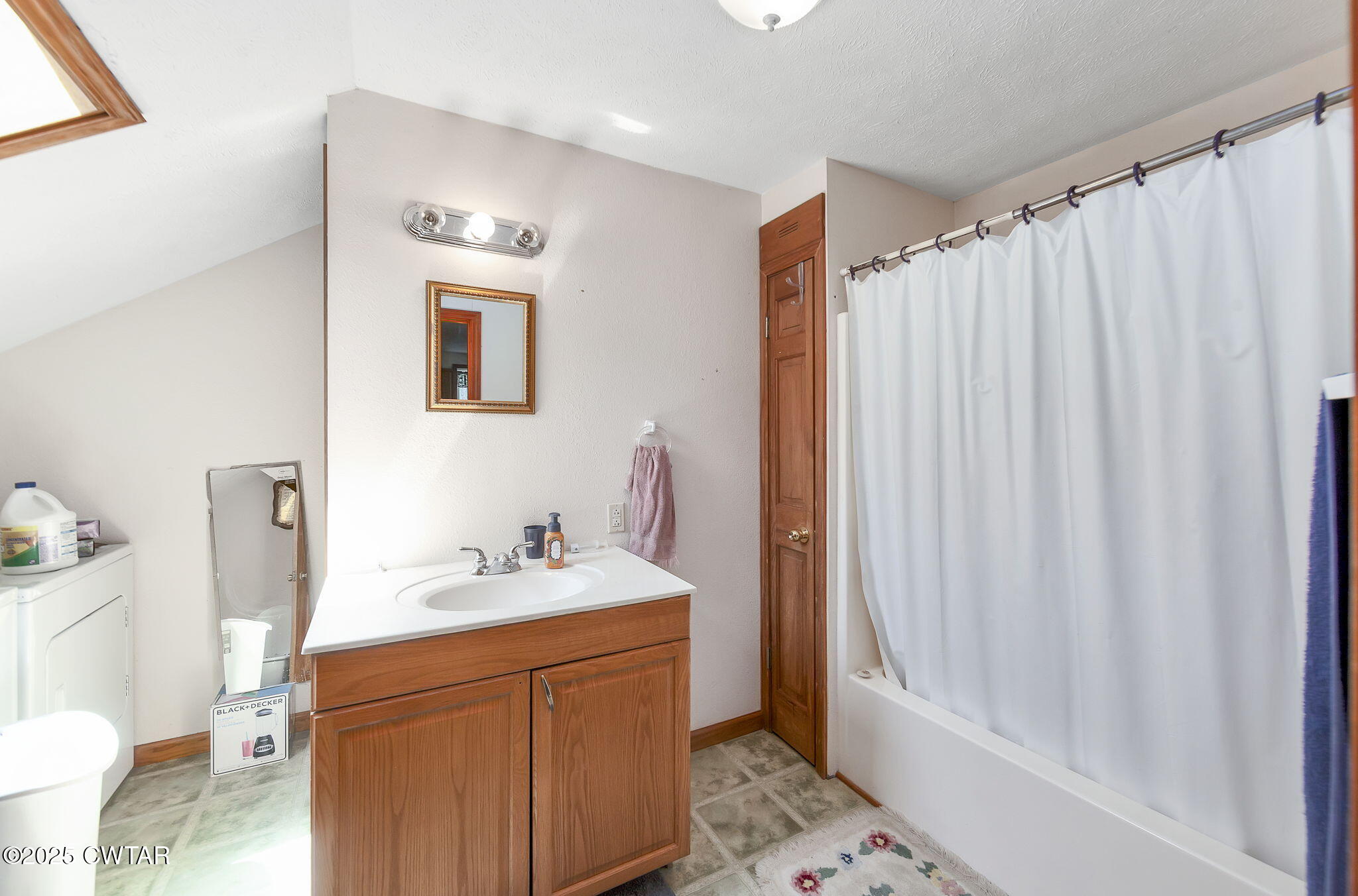 50 Braund Road Finger, TN 38334 - Photo 38 of 65 a bathroom with a sink a toilet and shower curtain