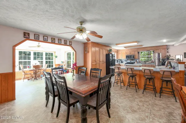 a kitchen with stainless steel appliances wooden floor and a refrigerator