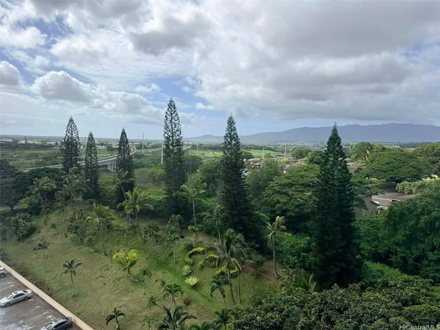 a view of a city with lush green forest