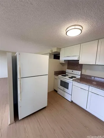 a kitchen with stainless steel appliances a refrigerator sink and cabinets