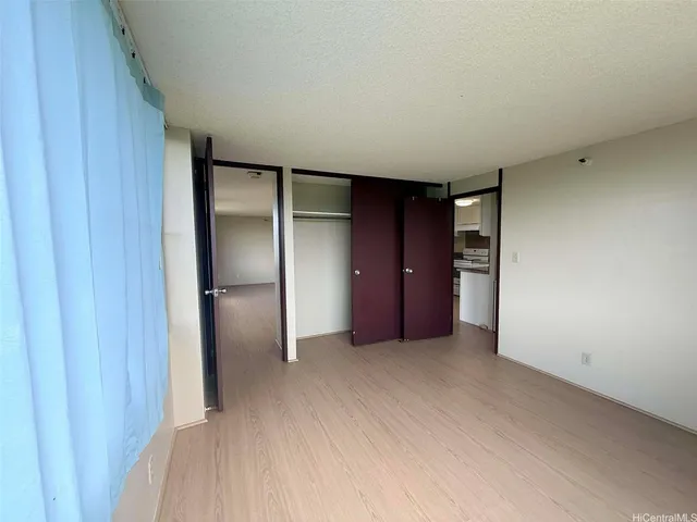 a view of an empty room and closet area