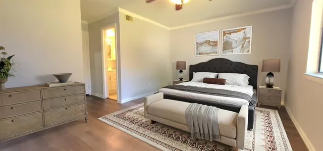 a bedroom with a bed and a lamp on dresser