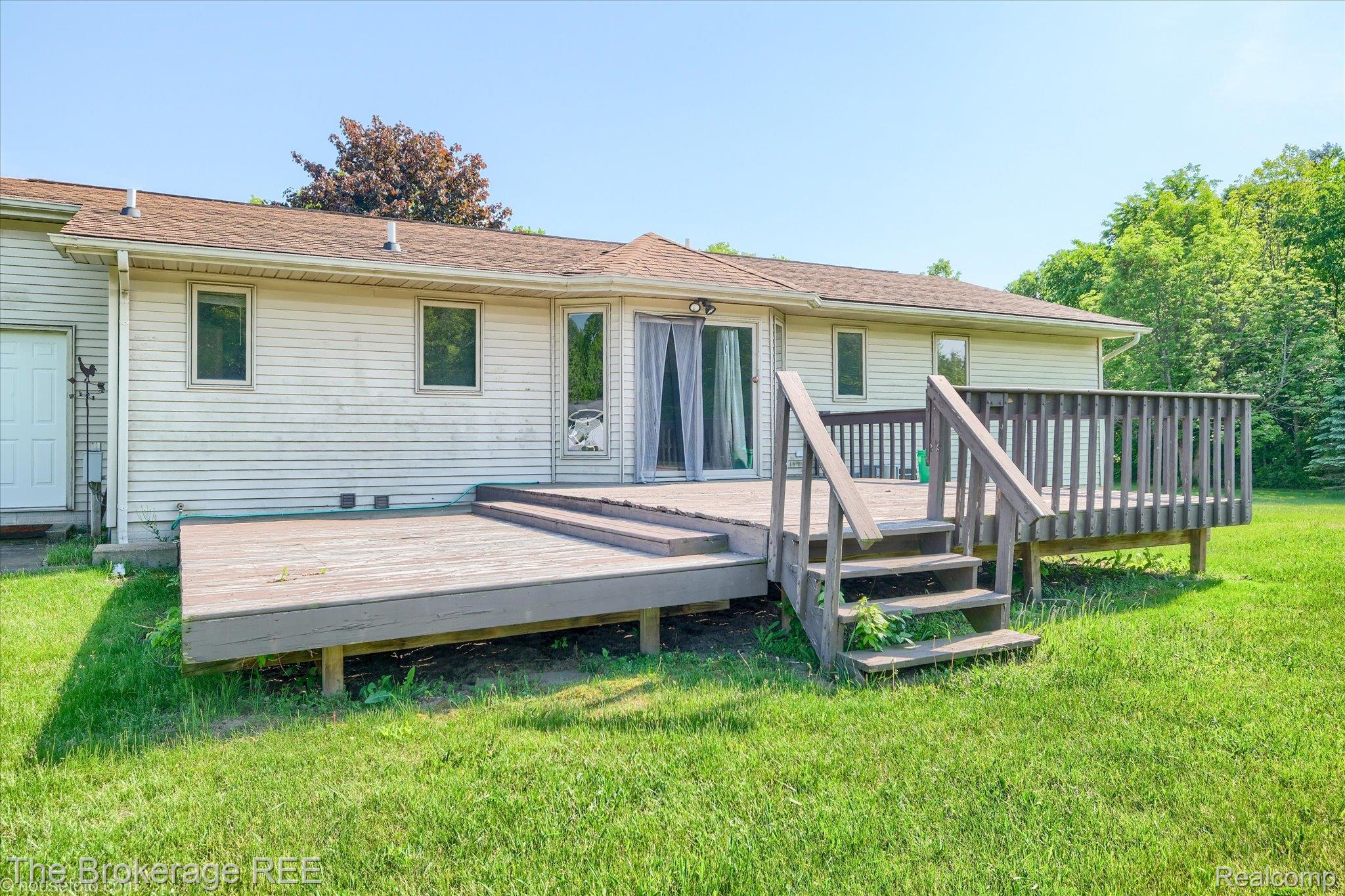 5495 East Coldwater Road Flint, MI 48506 - Photo 9 of 44 Rear exterior featuring a multi-level wood deck with railings and steps