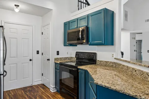 a kitchen with granite countertop stainless steel appliances and wooden cabinets