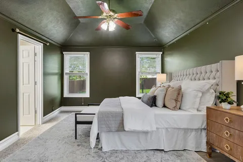 a bedroom with a bed and a chandelier