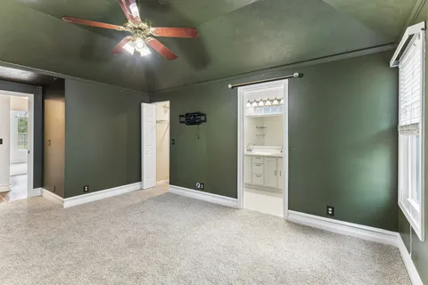 an empty room with closet and a chandelier fan