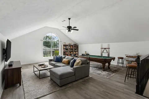 a living room with furniture a fireplace and a large window