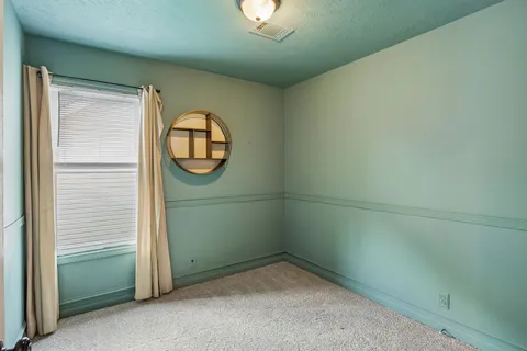 an empty room with a mirror