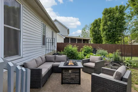 a view of backyard with seating space and plants