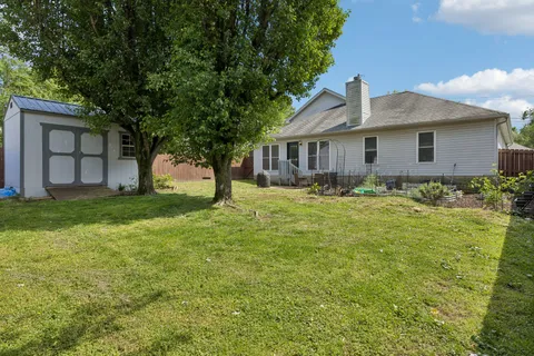 a front view of a house with yard and green space