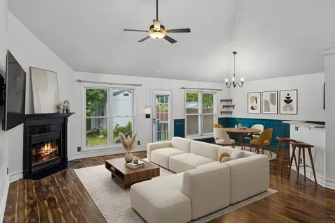 a living room with furniture fireplace and flat screen tv