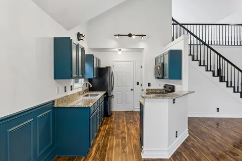 a kitchen with a sink and a refrigerator