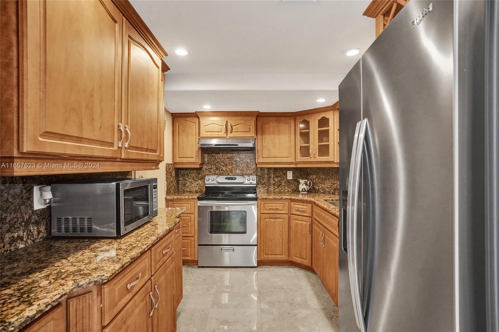 500 Bayview Drive, Unit PH20 Sunny Isles Beach, FL 33160 - Photo 18 of 41 a kitchen with stainless steel appliances granite countertop a refrigerator a stove top oven a sink and dishwasher