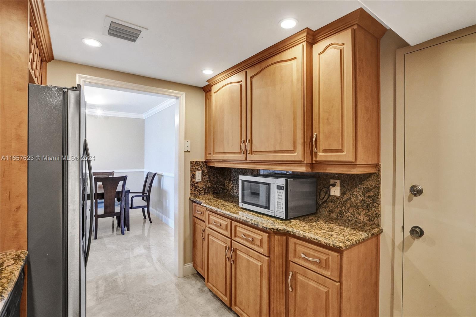 500 Bayview Drive, Unit PH20 Sunny Isles Beach, FL 33160 - Photo 19 of 41 a kitchen with stainless steel appliances granite countertop a stove a sink and a refrigerator