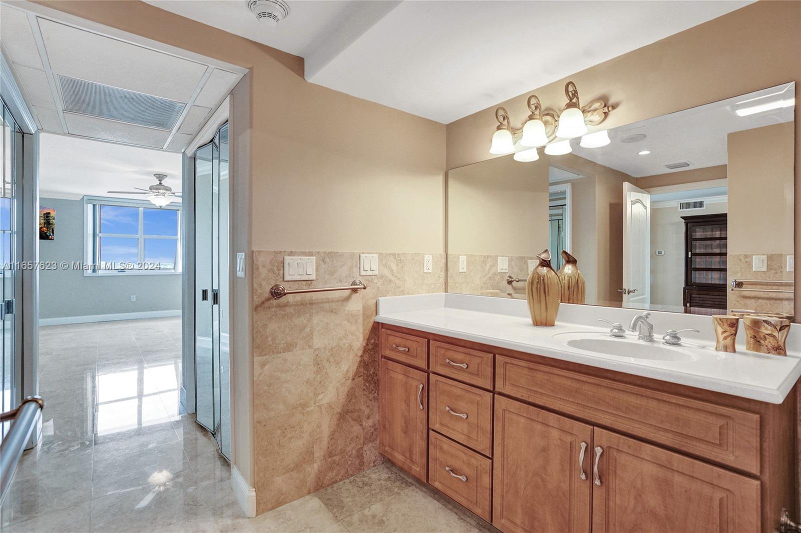 500 Bayview Drive, Unit PH20 Sunny Isles Beach, FL 33160 - Photo 30 of 41 a bathroom with a double vanity sink mirror and shower