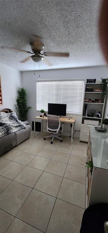 5005 Wiles Road, Unit 106 Coconut Creek, FL 33073 - Photo 12 of 19 a living room with furniture and a fireplace