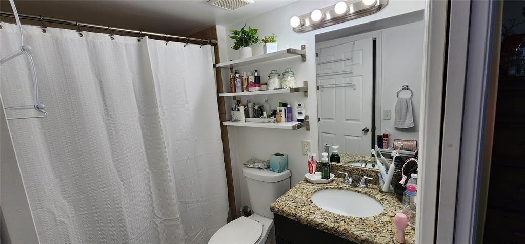 5005 Wiles Road, Unit 106 Coconut Creek, FL 33073 - Photo 13 of 19 a bathroom with a sink toilet and shower