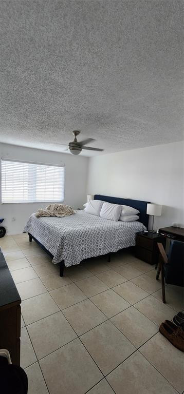 5005 Wiles Road, Unit 106 Coconut Creek, FL 33073 - Photo 16 of 19 a bedroom with a bed and a cabinets